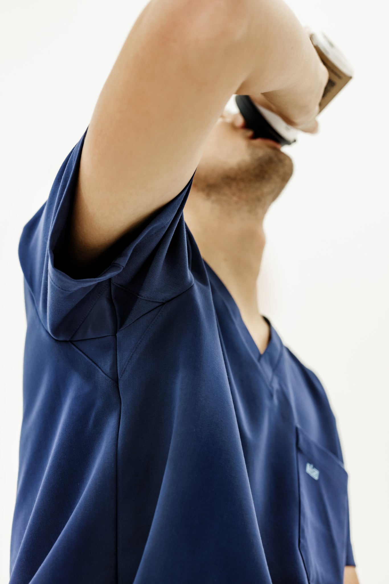 Comfortable navy V-neck scrub top designed for ease of movement and long wear.