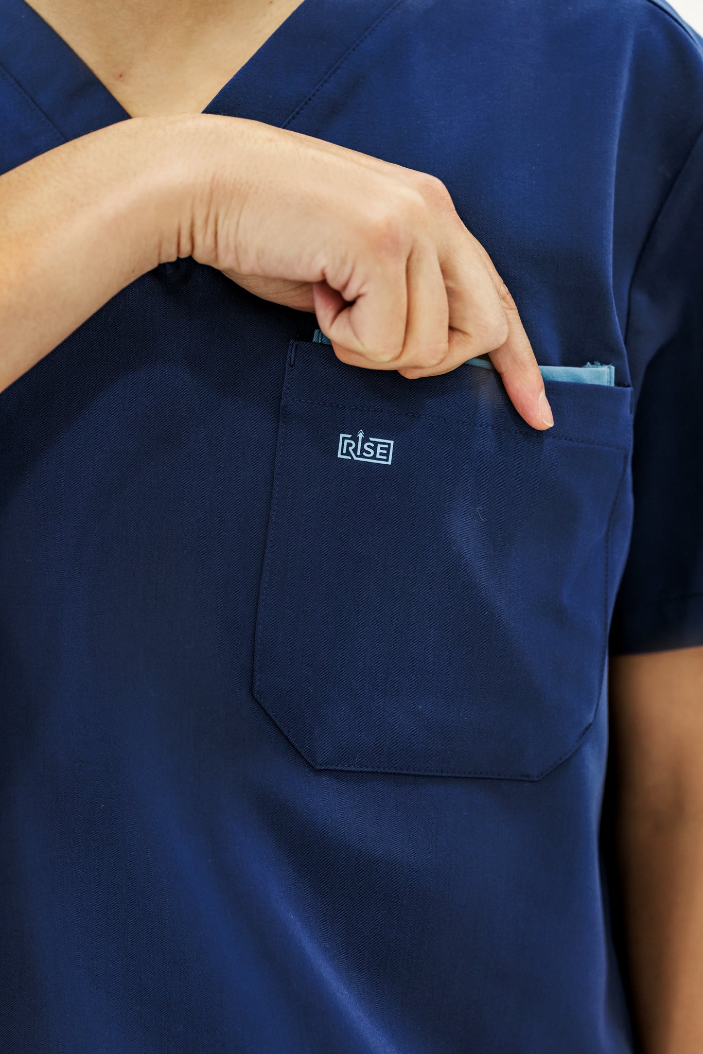 Sleek navy V-neck scrub top offering a flattering fit and all-day comfort.
