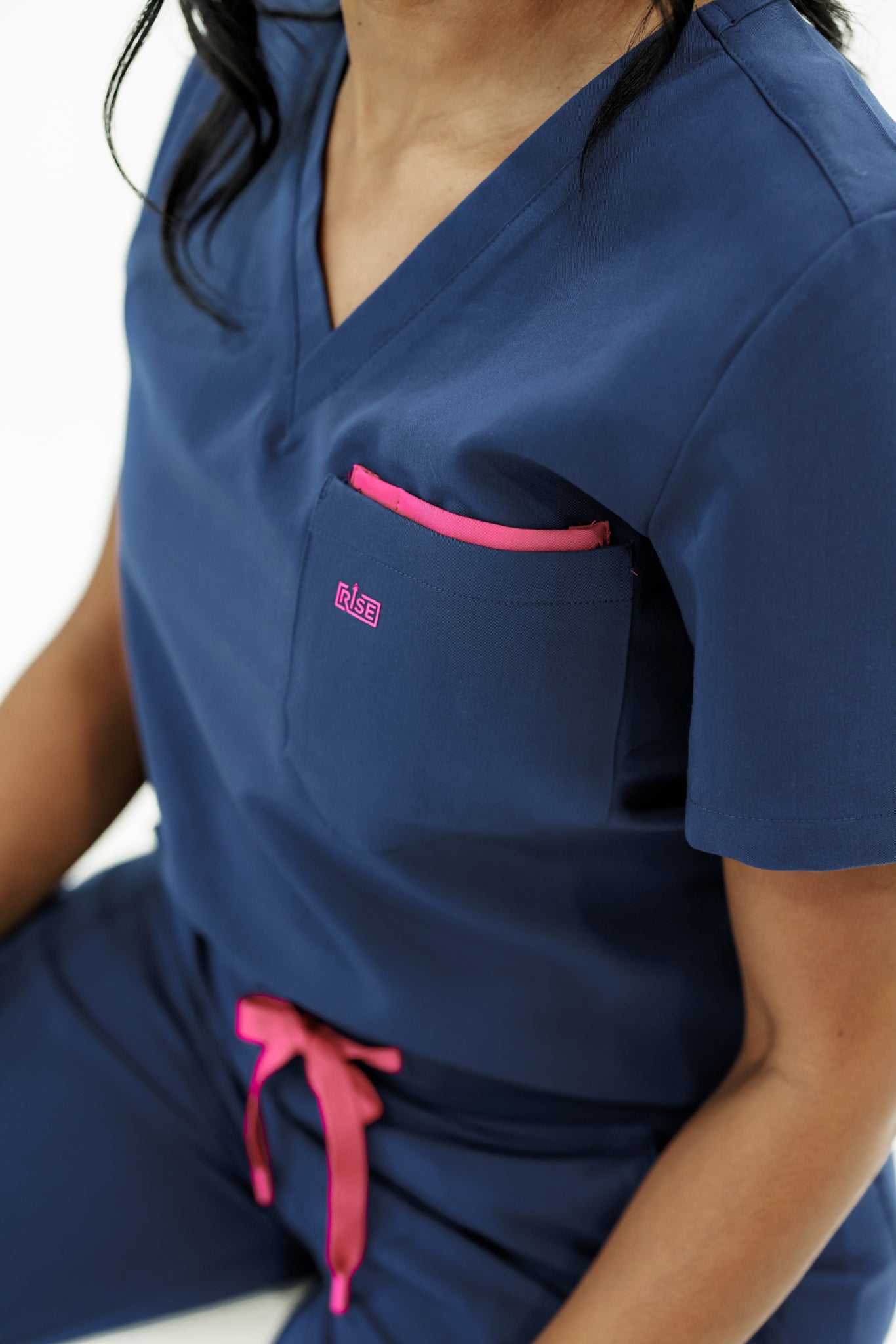 Stylish navy V-neck scrub top designed for comfort and flexibility during shifts.
