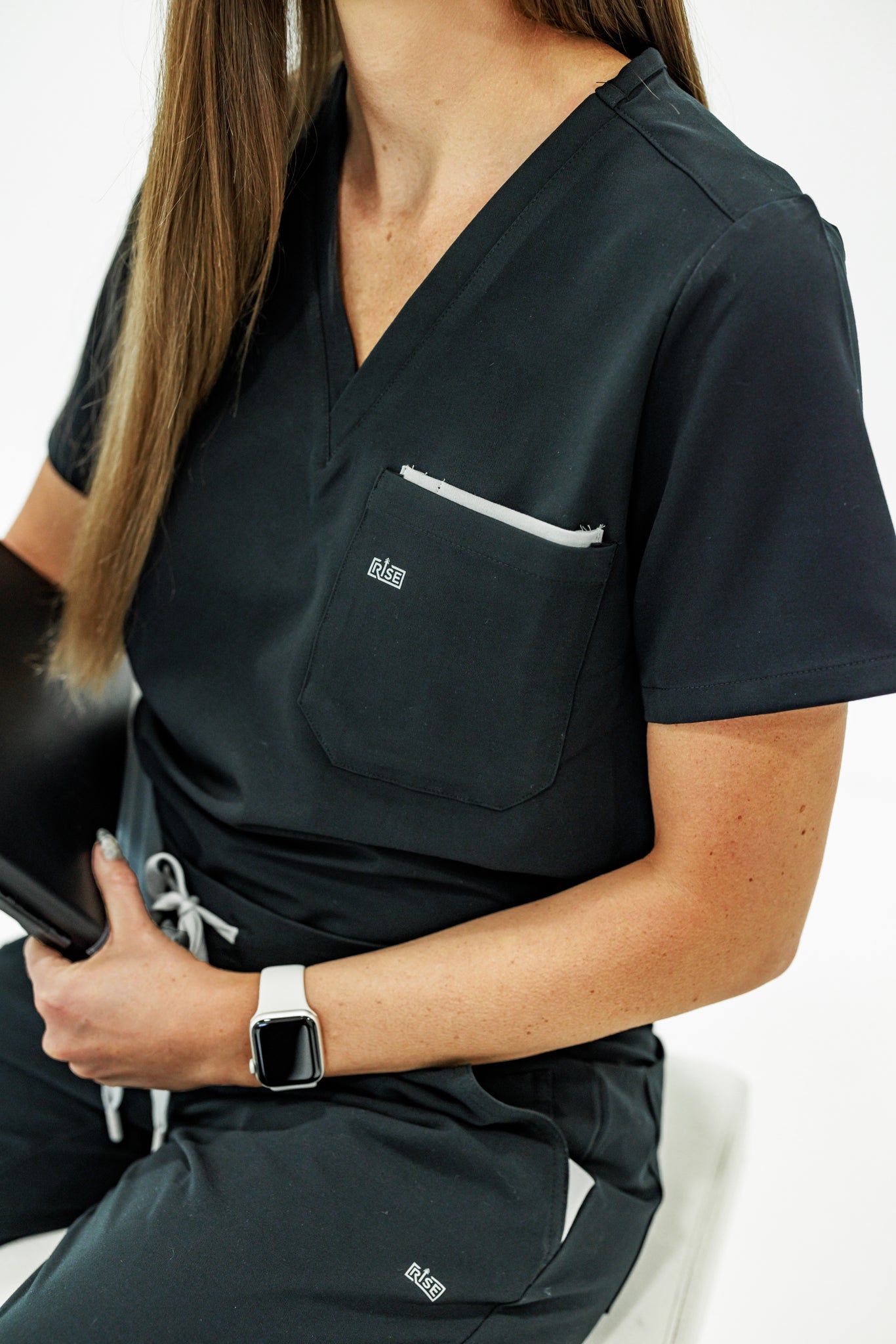 Professional black V-neck scrub top providing lasting comfort for busy medical workers.