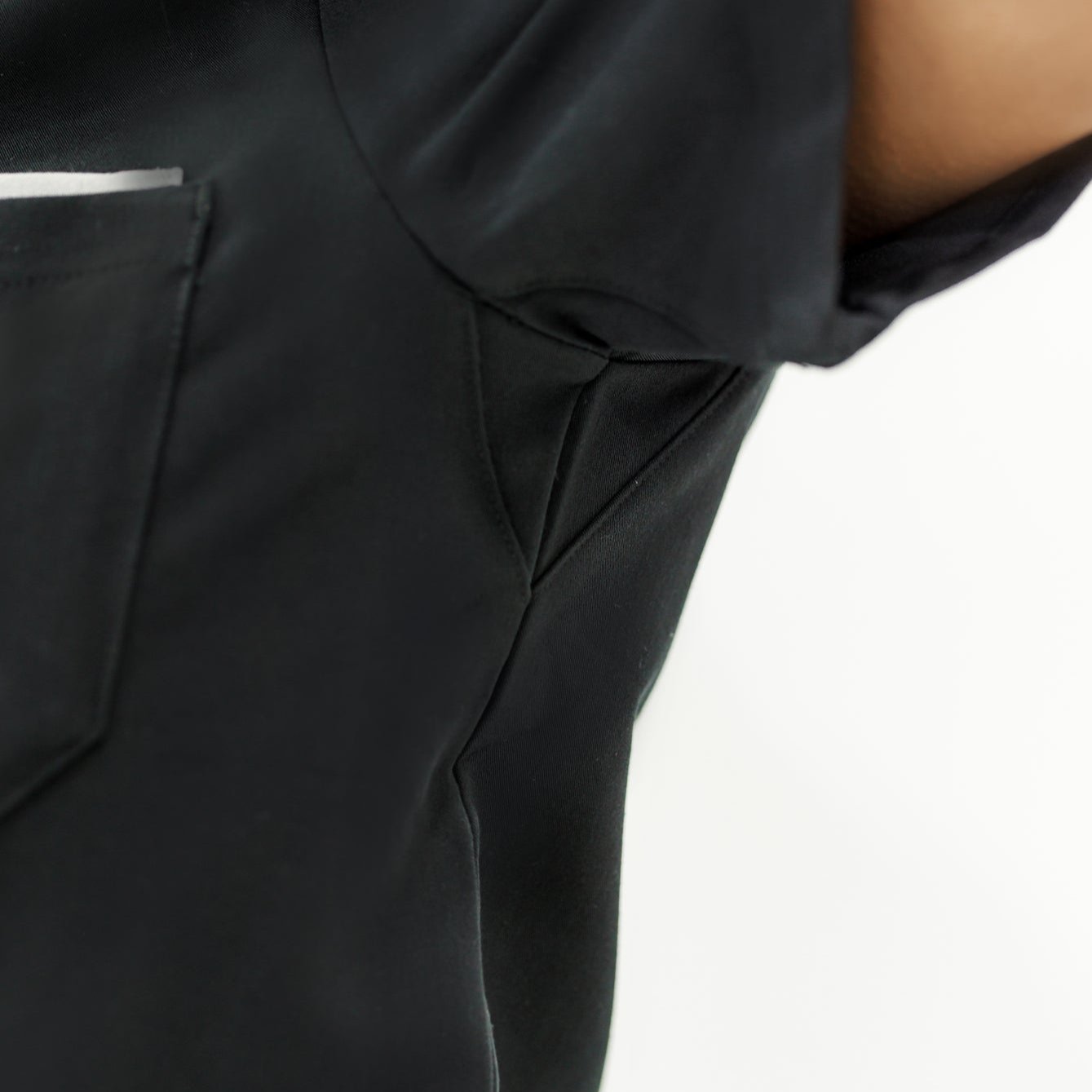 Durable black V-neck scrub top combining flexibility, breathability, and style for healthcare workers.