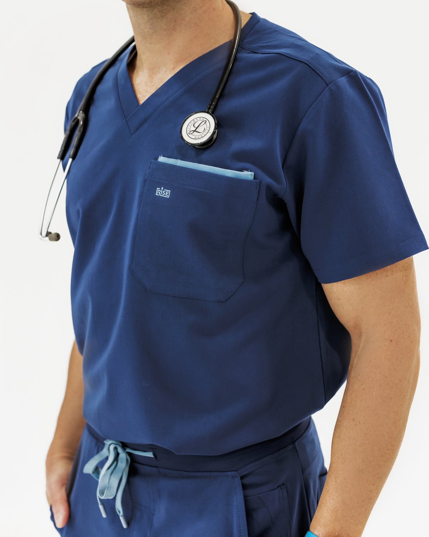 Stylish navy V-neck scrub top offering comfort and durability for healthcare professionals.