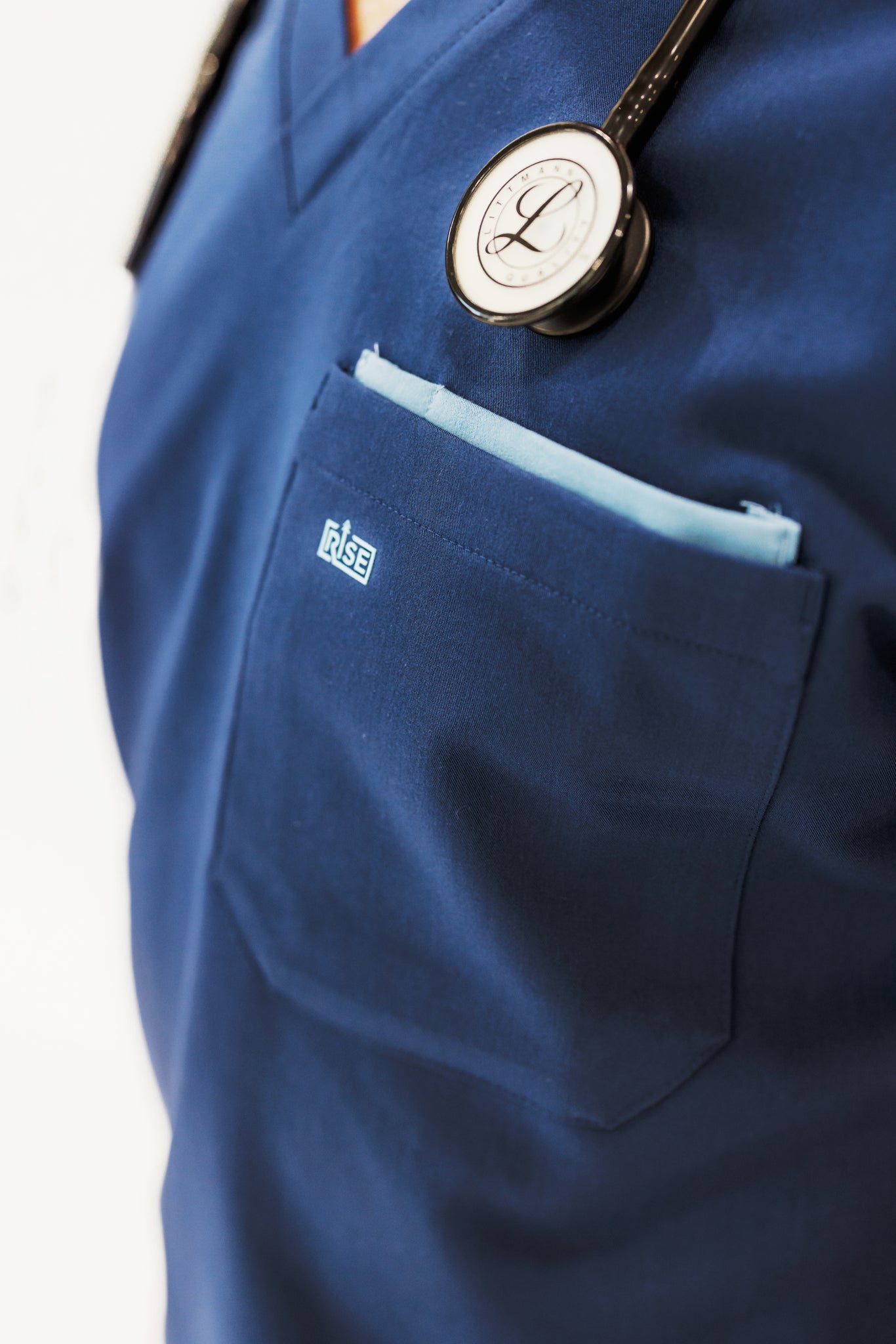 Navy V-neck scrub top providing comfort, breathability, and flexibility for long shifts.