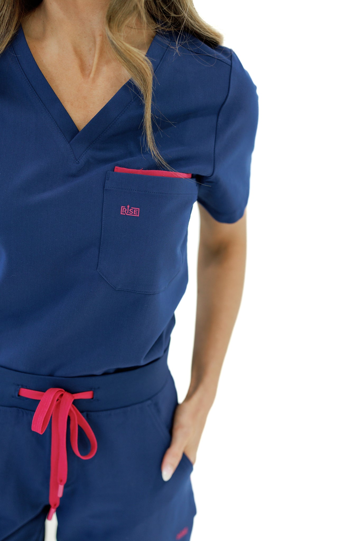 Modern navy V-neck scrub top designed for comfort and movement throughout shifts.
