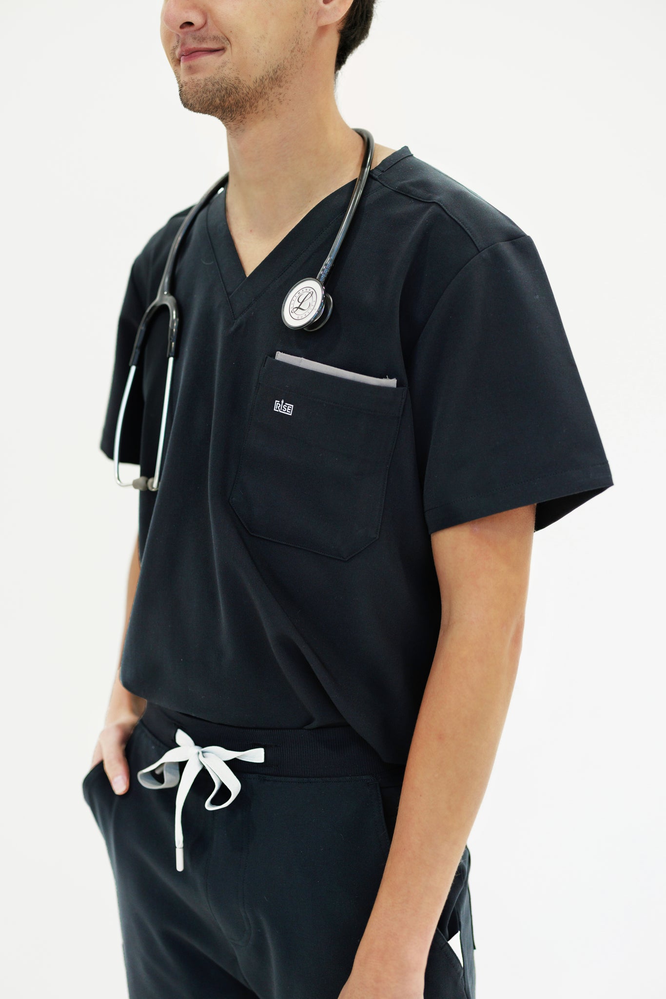Comfortable black V-neck scrub top designed for busy healthcare professionals.