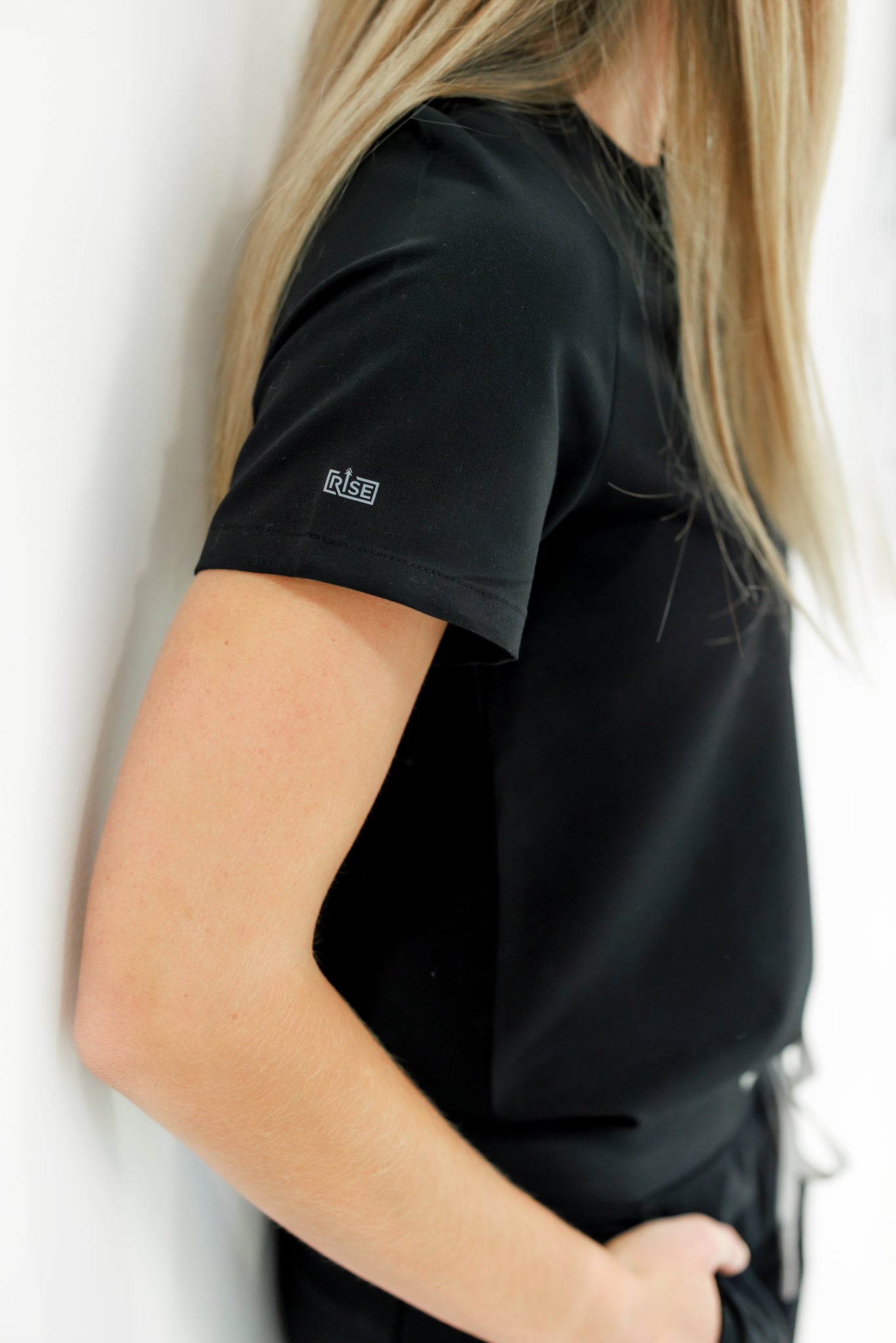 Sleek, professional black crew neck scrub top providing all-day comfort.