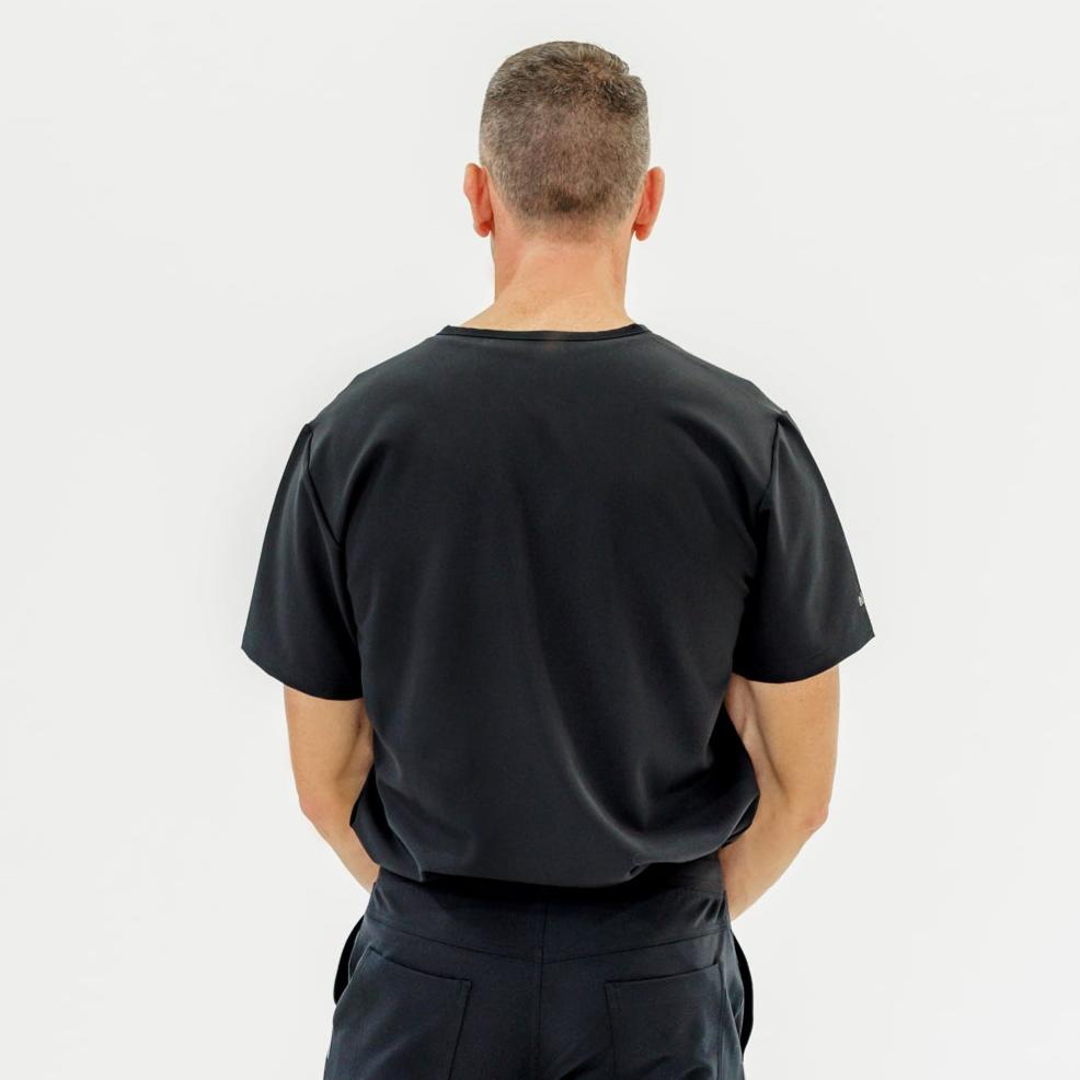 Sleek and stylish black V-neck scrub top designed for comfort and ease of movement.